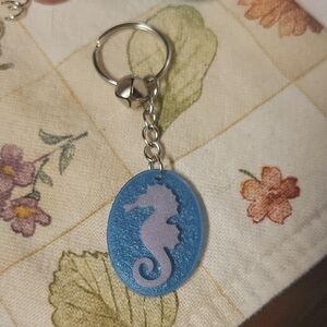 Pink Seahorse Keychain with Bell In Sparkly Blue Ocean-Water-Like Background